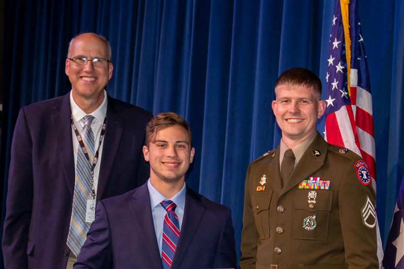 A student is honored for serving in the US Armed Forces after high school